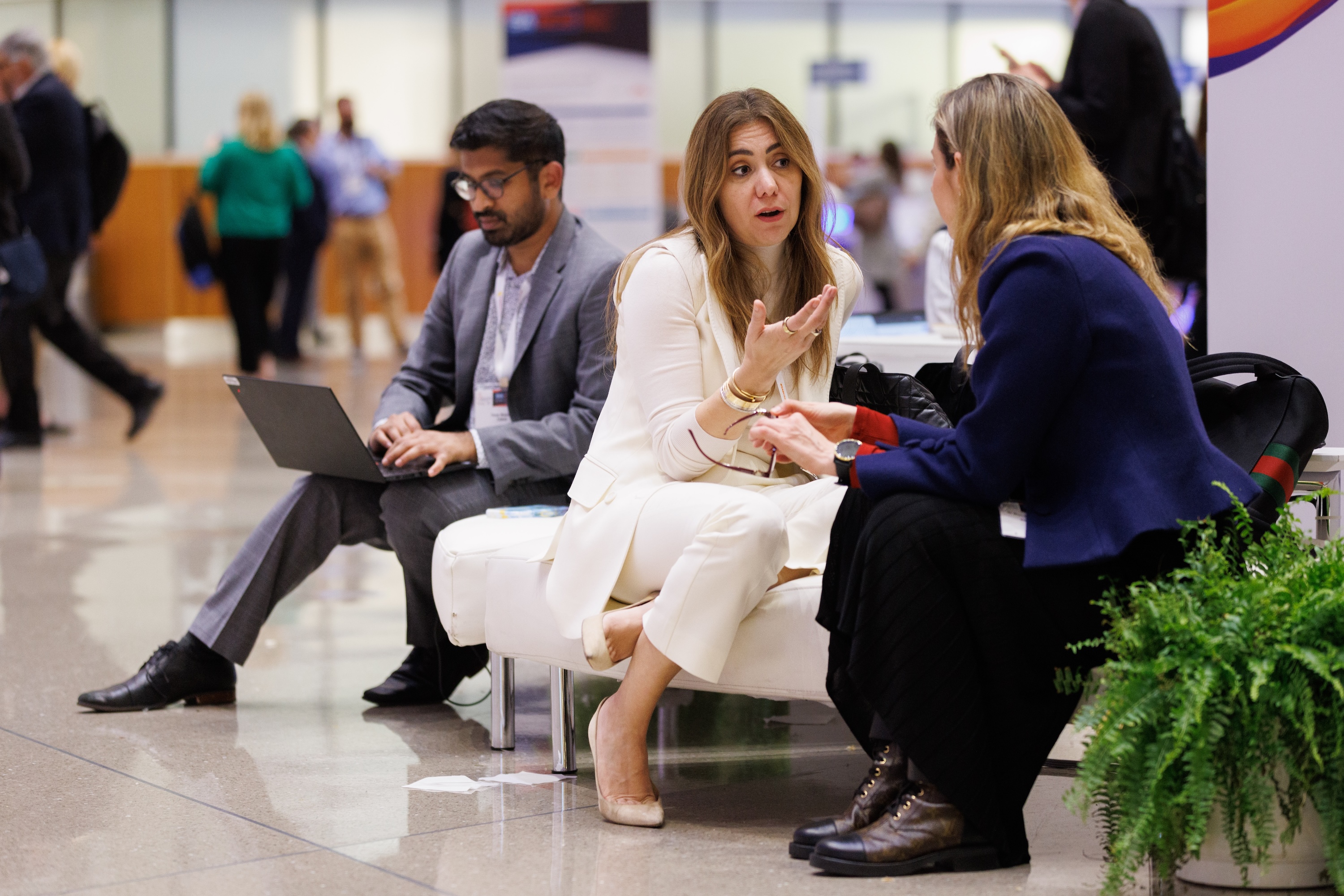 Attendees network at one of the charging stations provided at SABCS 2023.