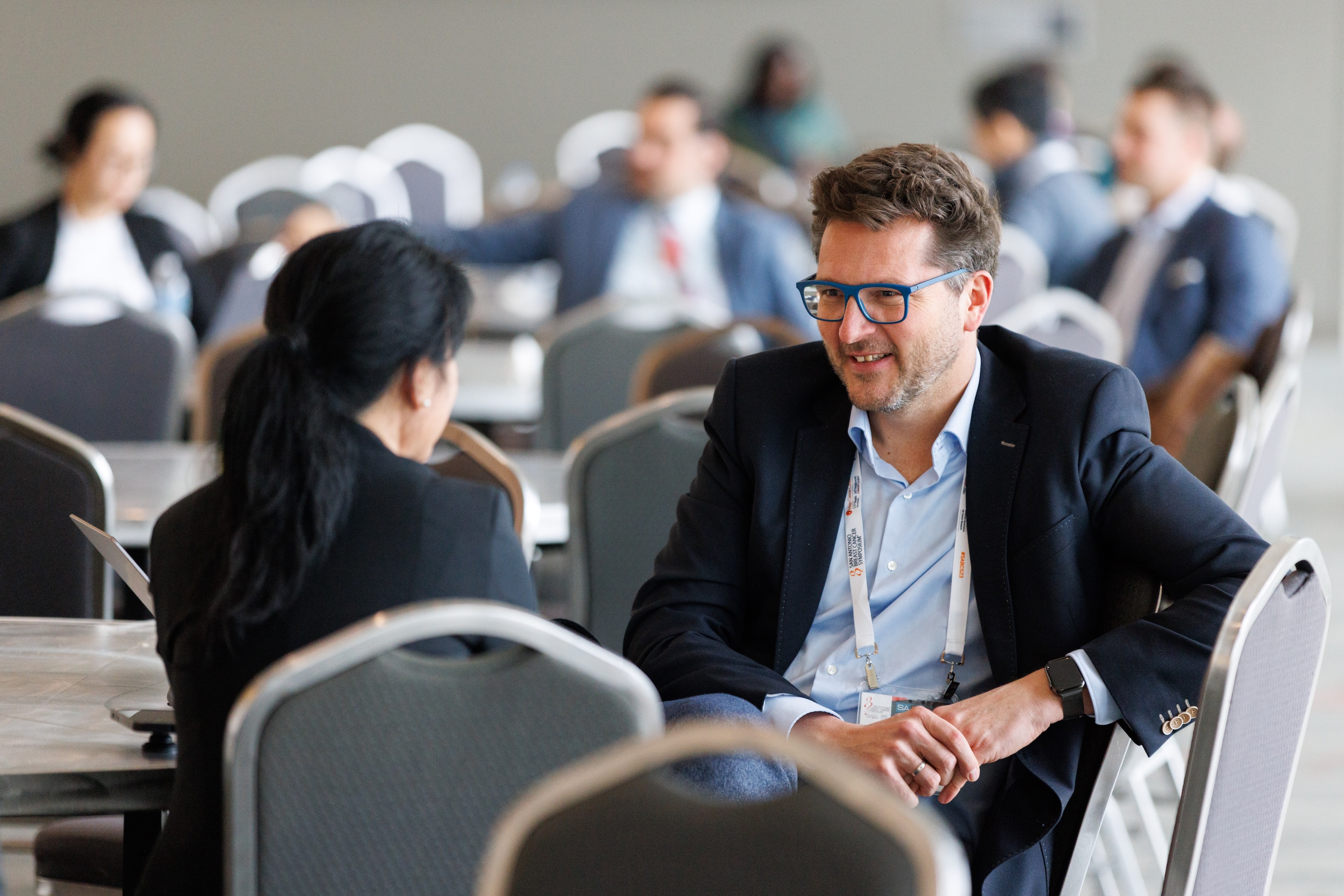 Attendees networking during SABCS 2023.