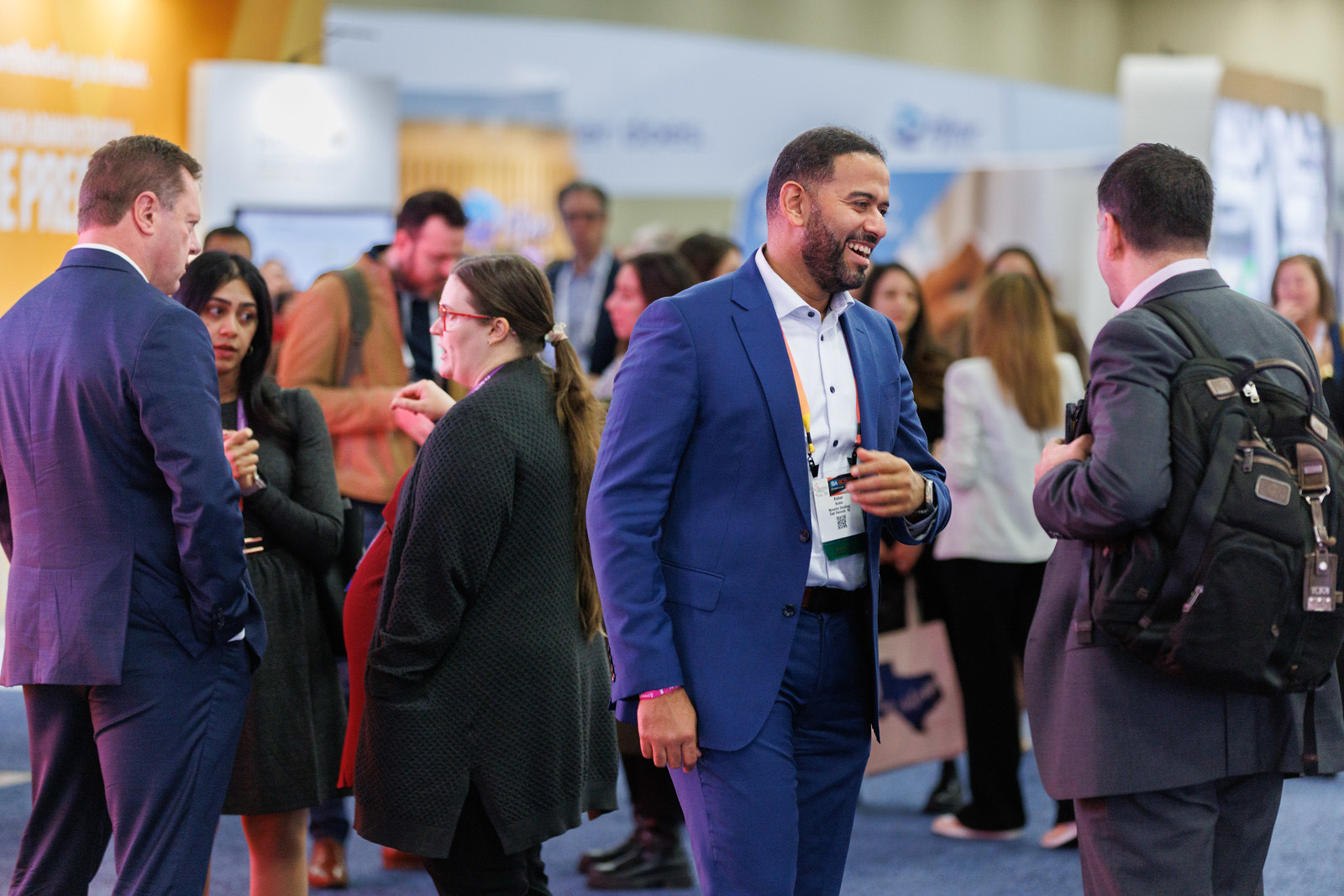 Attendees network during the exhibit show at SABCS 2023.