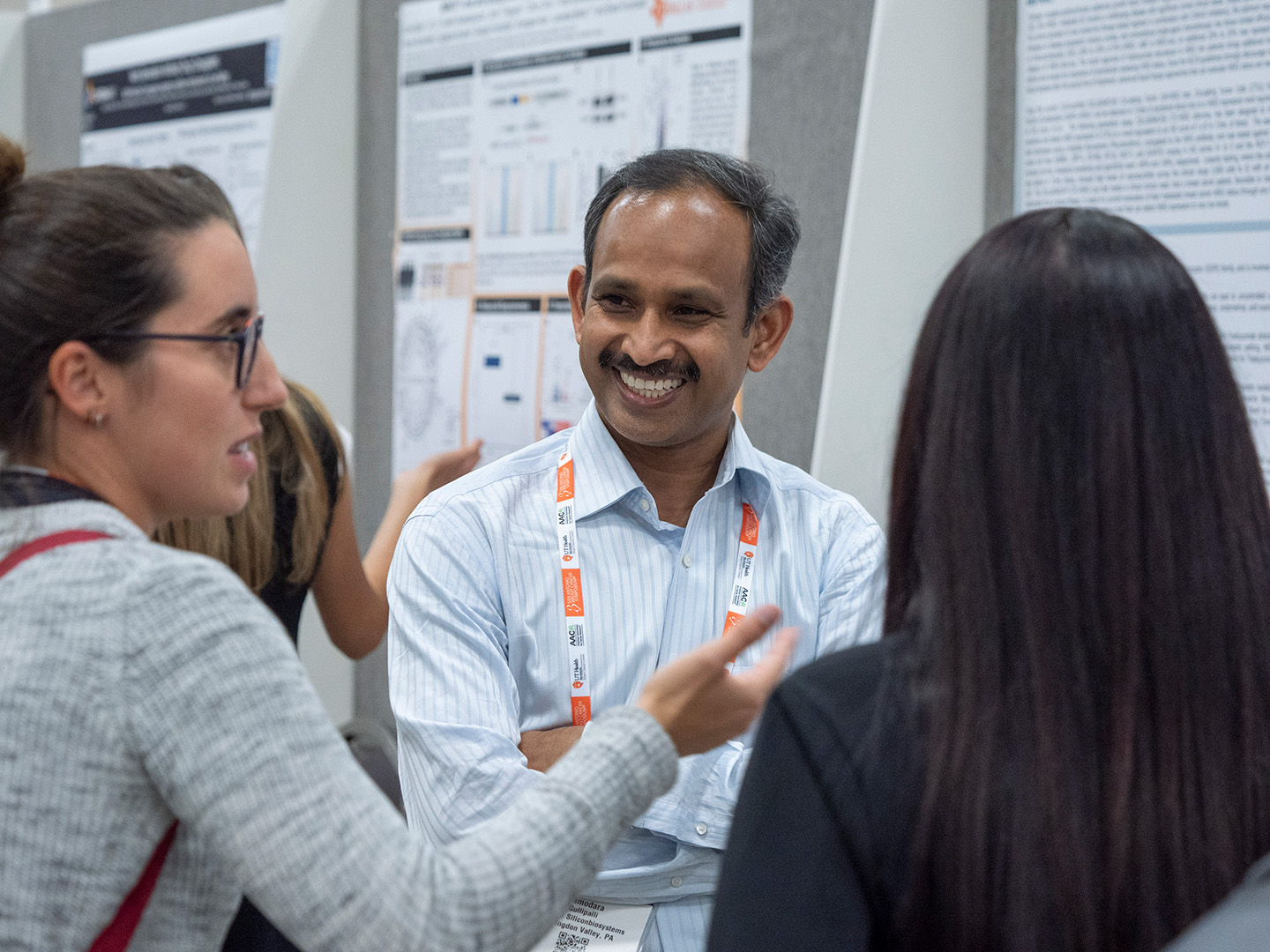 Poster presenters discuss their work with attendees at SABCS 2024.