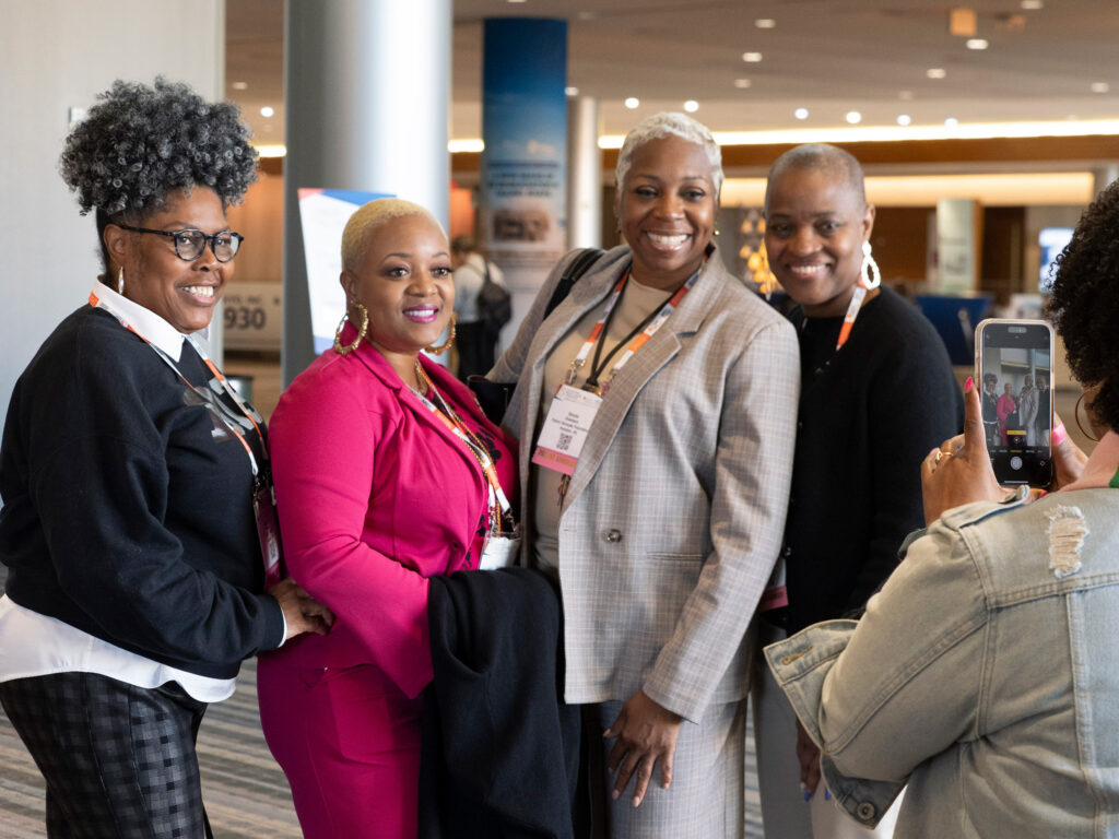 Patient advocate attendees pose for a photo during SABCS 2024.